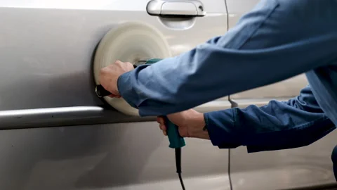 Close Up of mechanics man using tools to polish the car before painting or .. Stock-Footage 242778631
