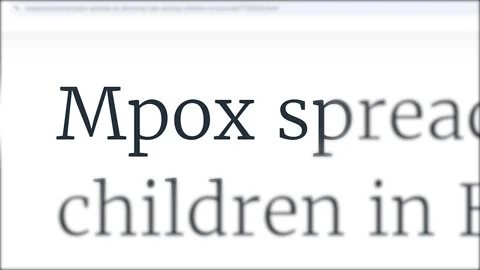 Close-up of media headlines discussing the monkeypox vaccine rollout amid rising Stock Footage 285311128