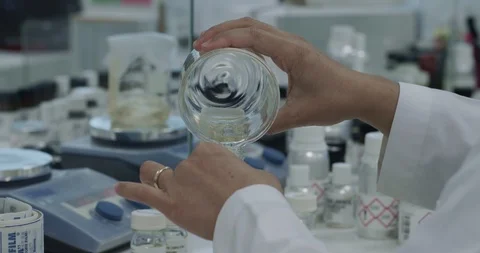 Close-up of medic pouring liquid from beaker. 4K video Stock Footage 126755209