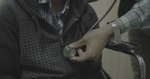 Close-up of a medical checkup using a stethoscope on a chest Vídeo Stock 327444105