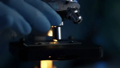 Close up of medical scientist working with microscope inside laboratory Stock Footage 147754617