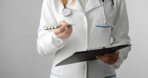 Close up of medical worker standing in studio with clipboard Stock Footage 126671654