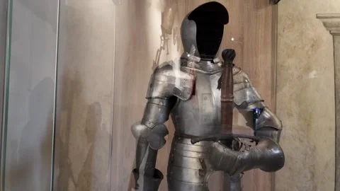 Close-up of a Medieval knight's decorated armor with an open helmet and a Stock Footage 314107330