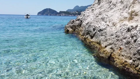 Close Up Mediterranean crystal clear turquoise water beach and bay Ionian sea Stock Footage 122956875
