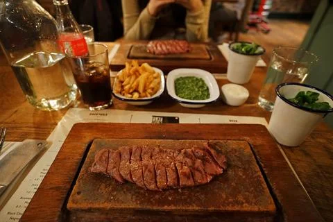 Close up Medium rare beef steak served with fries and cream spinach Stock Photos