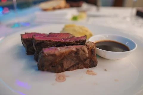 Close Up of Medium Rare Steak with Dipping Sauce on Plate Stock Photos