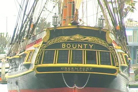 Close medium shot of HMS Bounty stern at dock Stock Footage 12446940