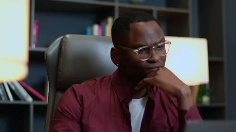 Close-up medium shot of a man in glasses on an online call from home, man in Видео 263630257