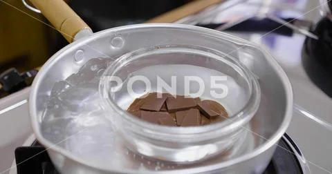 Close up melting chocolate in hot boiling water Stock Photos