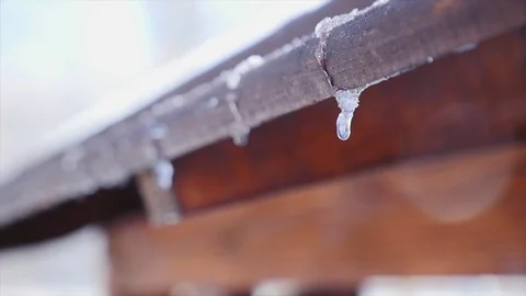 A close up of a melting drop and an icicle Stock Footage 72403593