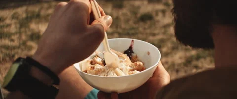 Close up of men with beard eating joghurt and fruits from a bowl Stock Footage 203584646