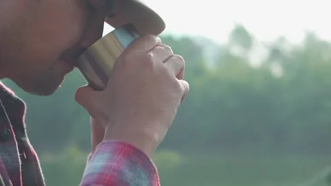 Close-up of men drinking coffee outdoors. Video stock 238432495