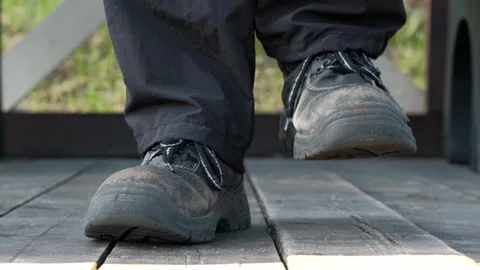 Close up of men feet in old worn shoes marching on spot on the wooden flooring. Stock Footage 246729685