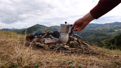 Close up of men hand making coffee on bonfire Stock Footage 118588304