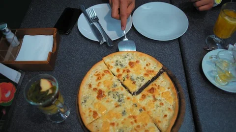 Close-Up, Men Hand Puts Cut Pieces of Pizza on Plates Stock Footage 101671430