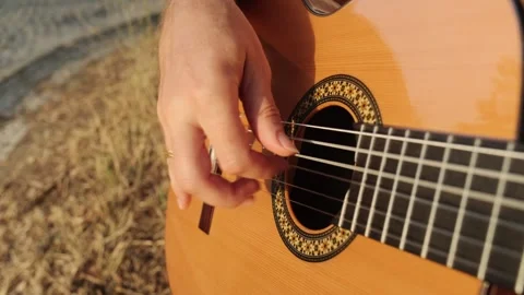Close-up men hands playing on classic guitar . Guitarist plays the guitar i.. Stock Footage 263554050