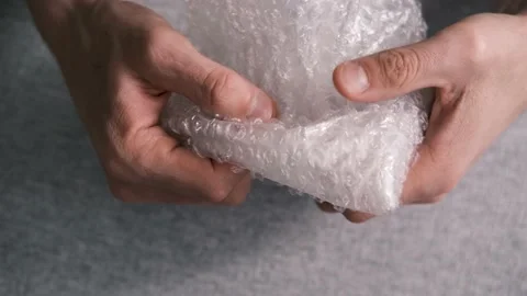 Close up of men hands playing with plastic  bubble wrap. Stock Footage 149594875