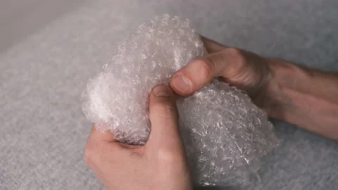 Close up of men hands playing with plastic  bubble wrap. Stock Footage 149596182