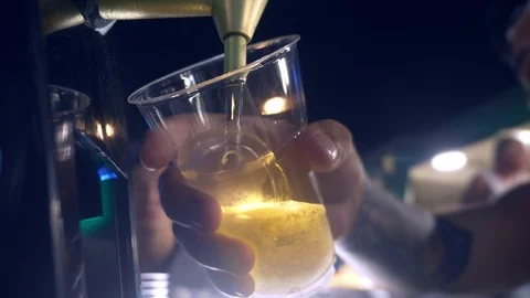 Close-up. Men hands pouring beer into a plastic cup. street food. Stock Footage 101005937