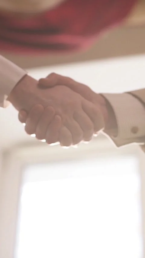 Close up of men shaking hands in office Stock Footage 326121960