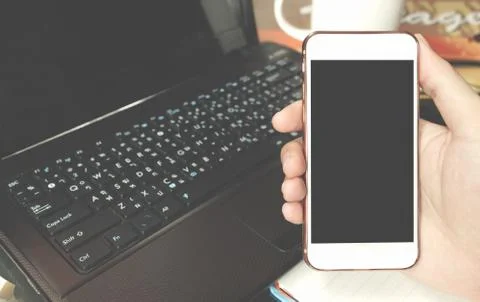 Close up of a men using smart phone with blank mobile and cup of coffee . S.. Stock Photos