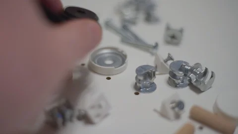 Close up men's hand puts plastic details for furniture Stock Footage 127976916
