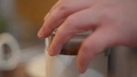 Close up men's hand takes coffee with a spoon from a coffee grinder Stock Footage 127977832