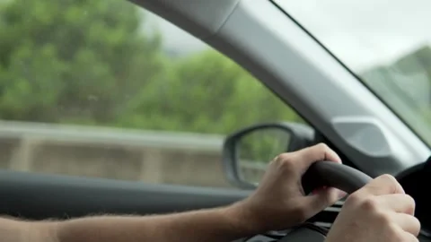 Close-up of men's hands behind the wheel of a car Stock Footage 249599706
