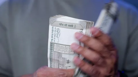 Close-Up of Men's Hands Holding Indian Rupee Notes — Financial Planning and Stock Footage 319973155