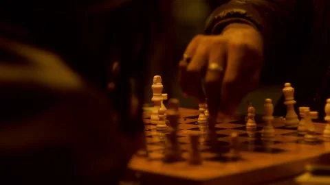 Close-up of Men's Hands Making Strategic Chess Moves: Urban Night Strategy and Stock Footage 331760070