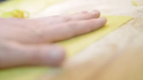 Close-up men's hands move a thin sheet of dough, prepared for cutting pasta Stock Footage 74532402