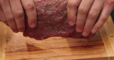 Close-up of men's hands rubbing spices into meat Stock Footage 256426646