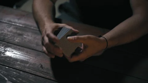 Close-Up, Men's Hands Stir A Deck of Cards on a Wooden Desk at Night in the Stock Footage 113119119