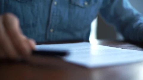 Close-up of men's hands taking ballpoint pen and signing document on table. Stock Footage 121886258