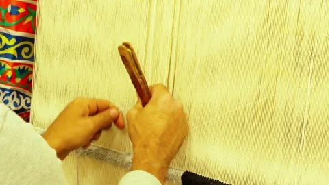 Close-up of men's hands weaving a carpet.  Handmade carpet weaving. Stock Footage 325469873