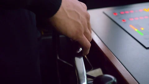 Close of a merchant marine students hands steering in a ship simulator Stock Footage 107092327