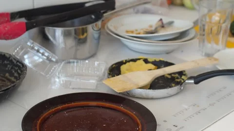 Close up of a messy and cluttered kitchen counter with dirty plates, pan an.. Stock Footage 291670306