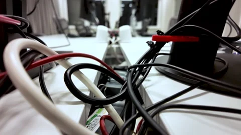 Close Up Of Messy Cables And Wires Behind Computer Monitors In Empty Office Stock Footage 325838928