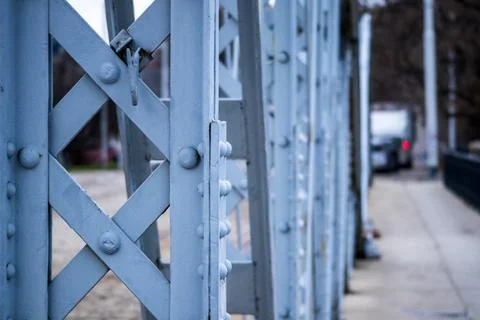 Close-up of a metal bridge structure with visible bolts and repeating pattern Stock Photos