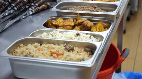 A close-up of metal containers with ready-made food in the dining room. Stock Footage 318659730