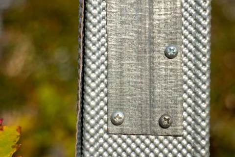 Close up of a metal corner bead protector with screws on a construction site Stock Photos