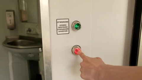 Close-up of a metal door on a train with a red and green light. Video stock 245098491