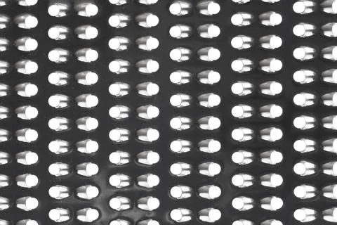 Close up of a metal grater surface with small holes, kitchen utensil texture  Stock Photos