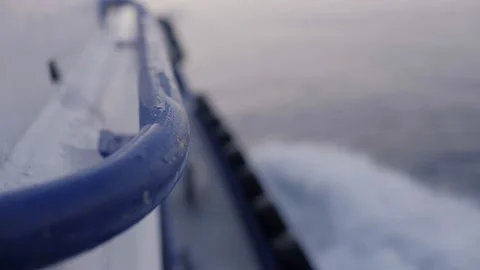 Close up metal handle side desk of fishing boat floating on waving sea water Stock Footage 153980254