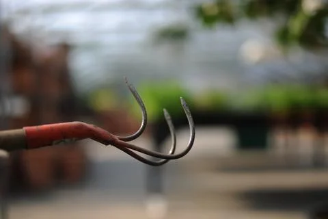 A close up of a metal hook with a red handle Stock Photos