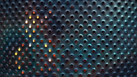 Close-up of metal mesh background lights fire on dark background. metal sheet Video stock 91730596