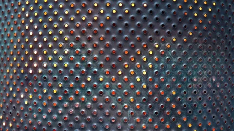 Close-up of metal mesh background lights fire on dark background. metal sheet Stock Footage 91730933