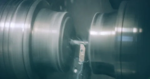 Close up of metal part rotating on high speed CNC lathe machine in factory Stockbeeldmateriaal 329680773