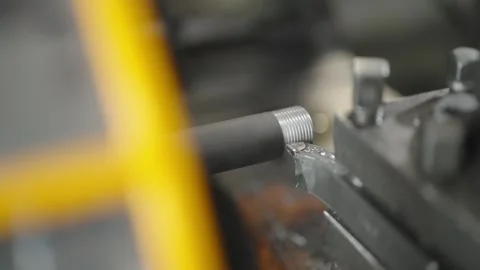 Close-up of a metal rod being threaded in a lathe machine Stock Footage 274490256