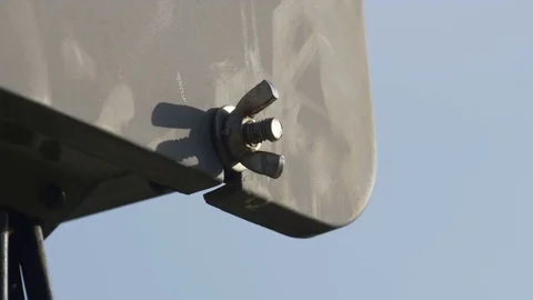 Close-up of metal screw which locking electric box/distributing box at sunset Vídeo Stock 81064350